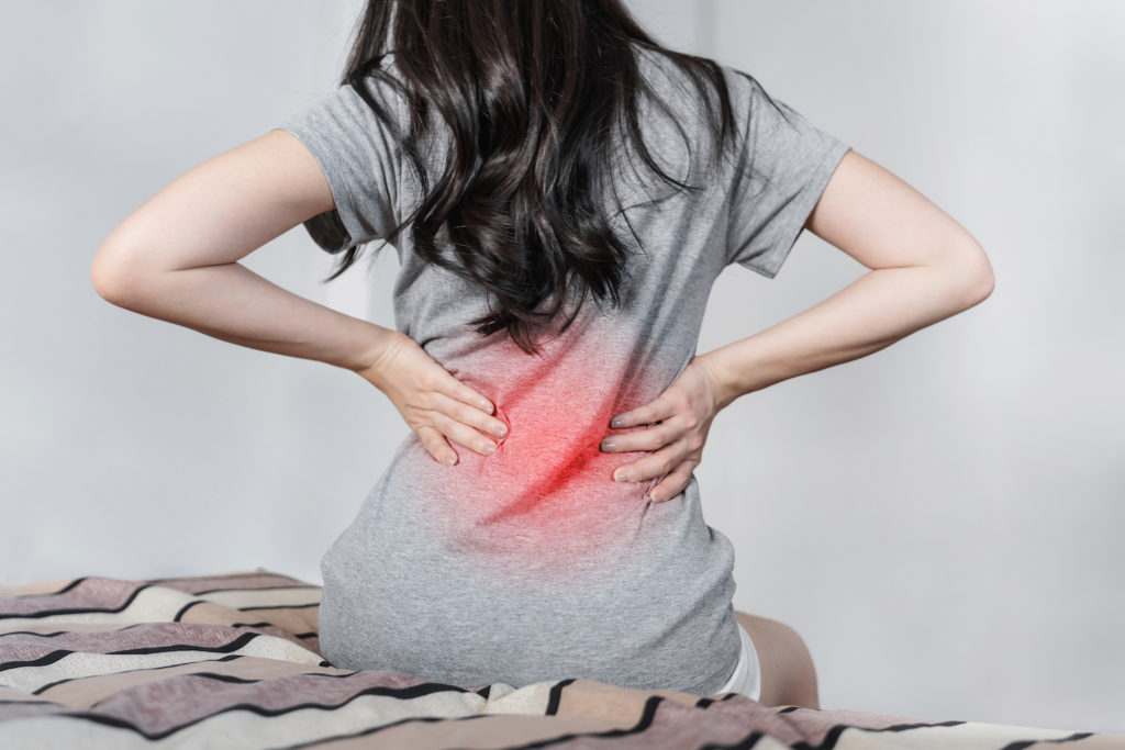 woman wearing gray shirt with back pain