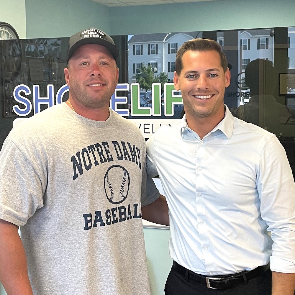 Dr. Brett Tave with patient wearing a black cap
